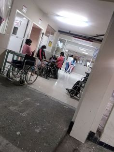 several people in wheelchairs are waiting for their turn at the airport terminal to get on or off