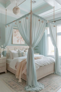 a canopy bed in a bedroom with blue walls and curtains on the windowsills