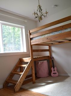 there is a bunk bed with stairs to the bottom and a pink guitar on the floor