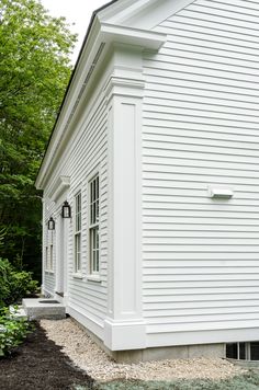 a white house with black roof and windows