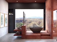 a large bath tub sitting in the middle of a bathroom next to a window with mountains behind it