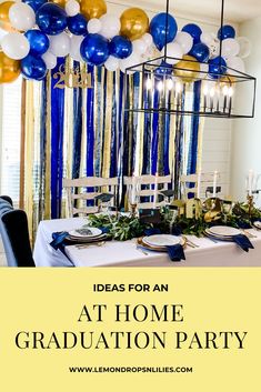 an at home graduation party with blue, gold and white balloons hanging from the ceiling