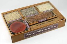 four different types of spices in a wooden box