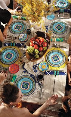 a group of people sitting around a table with plates on it