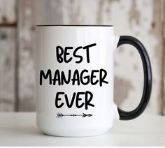 a white and black coffee mug with the words best manager ever