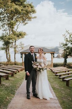 Bride and groom pose for couple portrait in front of coastal views at Watermouth Cove Wedding Groom And Groomsmen Outfits, Groomsmen Outfits, Grace Elizabeth, Green Bridesmaid, Wedding Pets, Green Bridesmaid Dresses