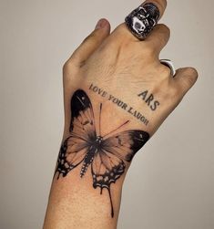 a hand with a butterfly tattoo on it's wrist and the words abs above it