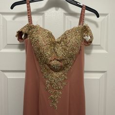 a dress hanging on a hanger in front of a door