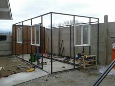 a house being built in the middle of a construction site with windows and sidings