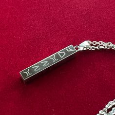 Get your name and a loved one's name engraved in Aurebesh on this stainless steel pendant. The left side says "I love you" and the right side says "I know"- the famous exchange between Han and Leia in Empire. Your two names will be in Aurebesh on the front and back sides.  A nine inch chain with extender is included.  Due to the limited space (the pendant is only a little over an inch long), please be aware that long names may be small. Etched Stainless Steel Jewelry For Gifts, Etched Stainless Steel Necklace As Gift, Etched Stainless Steel Necklace For Gift, Engraved Stainless Steel Rectangular Jewelry, Stainless Steel Necklaces With Engraved Text For Gifts, Rectangular Stainless Steel Necklaces With Engraved Text, Personalized Sterling Silver Rectangular Pendant Necklace, Engraved Stainless Steel Necklace With Square Pendant, Engraved Stainless Steel Square Pendant Necklace