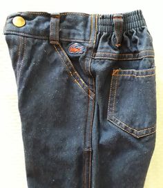 "Vintage Izod brand toddler jeans feature zip front closure and elastic back waist for a comfy fit are a rare find. Features:   Red Alligator logo on front left side below the waist   Bright orange top stitching   High waisted styling   Fly and snap front closure   Belt loops   2 front and 2 back pockets   Straight leg Tag Size 2T (see measurements for proper fit) Style 8190T Izod Lacoste Infants & Toddlers Made in The Philippines Measurements (flat):   Waist - 7 1/2\" - 9 1/2\"   Inseam - 11 1/ Alligator Logo, Back Jeans, Izod Lacoste, Toddler Jeans, Vintage Toddler, Orange Top, Jeans Kids, Fit Style, Comfy Fits