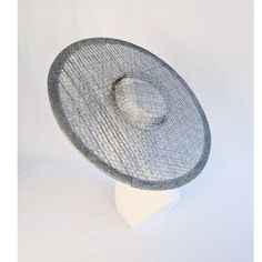 One cartwheel woven sinamay straw hat base in slate blue / blue gray that measures approximately 17.25" (43.8cm) in diameter. Crown is 1.25" (3cm) high. The edges of the brim are finished in wired sinamay. The multi-layer stiffened sinamay straw has a great sturdy weave and provides excellent support for your millinery creations. This is NOT a ready to wear finished hat and will not stay on your head unless you add a head band or elastic to wear. Add embellishments of your choice.  Sinamay is a natural material and you may see some color striations in the weave. This is not a defect, but is the result of how different natural fibers respond to dye. A nice high quality base - I know you'll be pleased! This hat base is listed separately in six different colors. Check my listings for those... Blue Woven Straw Hat With Wide Brim, Blue Woven Wide Brim Sun Hat, Blue Wide Brim Woven Straw Hat, Blue Wide Brim Woven Sun Hat, Silver Wide Brim Hat For Beach, Blue Panama Hat For Kentucky Derby, Blue Woven Hat With Curved Brim, Cartwheel Hat, Hat Form