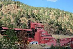 a large red building sitting on the side of a mountain