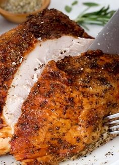 a piece of meat on a plate with a knife and fork