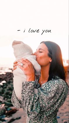 a woman holding a baby in her arms with the words i love you on it