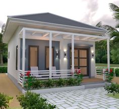 a small house with porches and white railings on the front door is surrounded by greenery