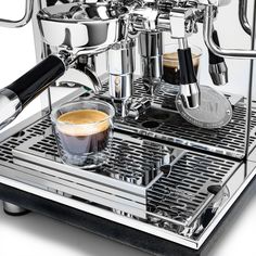 an espresso machine with two cups of coffee