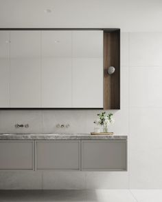 a white bathroom with two sinks and mirrors