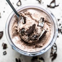 an ice cream sundae with oreo cookies in it on a white table top