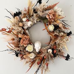 a wreath with dried flowers and feathers