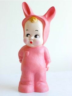 a pink toy with ears and nose is standing