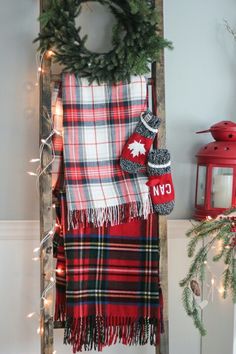 a ladder decorated with christmas decorations and plaid scarves