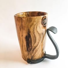 a wooden mug with a metal handle on a white background, the cup is shaped like a tree trunk