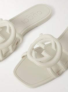 GUCCI Rubber slides | NET-A-PORTER Designer Flat Slides For Beach, Modern Sandals With Logo For Summer, Modern Logo Sandals For Summer, White Gucci Sandals With Branded Insole, Gucci Slide Sandals For Summer, Gucci Summer Slide Sandals, Designer White Gucci Slides, White Designer Gucci Slides, Luxury White Gucci Sandals