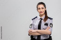 a woman police officer standing with her arms crossed