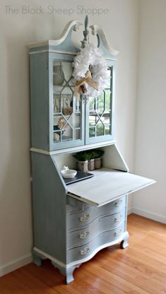 an old china cabinet is painted blue and white