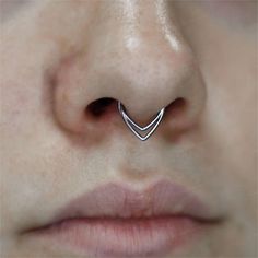 a woman's nose with a small curved nose ring