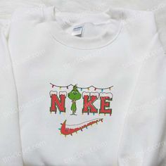 Baby Grinch Xmas x Nike Embroidered Shirt, Christmas Embroidered Hoodie, Nike Inspired Embroidered Sweatshirt Welcome to Tinicloset, the ultimate destination for fashion-forward individuals seeking a touch of whimsy, creativity, and warmth in their wardrobe. Our passion lies in crafting custom embroidered apparel that transcends ordinary clothing, and with every stitch, we strive to spark curiosity and excitement in our customers. Our collection features a delightful range of custom embroidered Christmas Nike Sweatshirt, Christmas Nike Crewnecks, Christmas Crewneck Nike, Nike Embroidery Christmas Sweatshirt, Grinch Nike Sweatshirt, Christmas Gift Images, Baby Grinch, Christmas Attire, Funny Christmas Sweaters