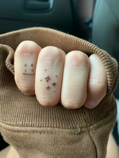 someone has two fingers with small stars on them