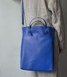 Zemoneni large size leather tote bag,  with two knots handle design.  material : 100 cowhide leather.  size : 30 (w) x 39 (H) x 8 (D) cm.  shoulder leather strap adjustable lenght in 110-120cm. other color available under required. Blue Rectangular Shoulder Bag With Rolled Handles, Modern Blue Bags With Rolled Handles, Blue Leather Shoulder Bag With Rolled Handles, Everyday Blue Soft Leather Bucket Bag, Blue Shoulder Bag With Double Handles, Blue Leather Handles Double Handle Bucket Bag, Blue Shoulder Bag With Rolled Handles For Daily Use, Blue Soft Leather Satchel For On-the-go, Blue Shoulder Bag With Rolled Handles For Shopping