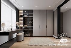 a modern bedroom with black and white walls, wood flooring and large closets