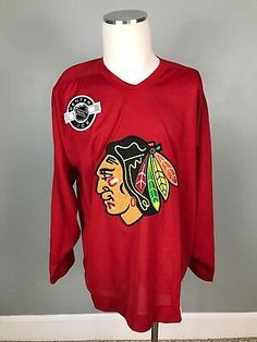 a red shirt with the chicago black hawks logo on it is sitting on a mannequin