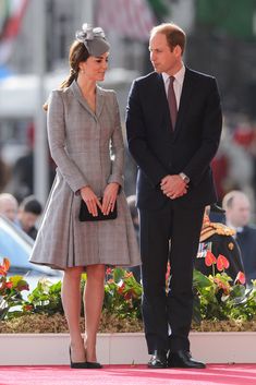 prince william and kate are standing next to each other