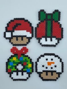 four pixel art christmas ornaments made out of legos