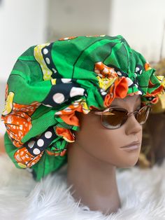 Adjustable Stylish Satin Bonnet made with Ankara Fabric: Bonnets are stylish and multi-functional. They can be worn to protect your hair while you sleep, as a scrub bonnet or as a fashion statement. They make the perfect accessory for date night, running errands, exercising, yoga, brunch, hanging out with friends/family, appointments, walking the dog, etc. Description: ✨100% Cotton/Ankara Fabric ✨ Light weight ✨ Seal Moisture for your hair ✨ Reduce Frizz ✨Reversible (Satin lined) ✨ Adjustable St Adjustable Green Bonnet Cap, Casual Green Headwrap One Size Fits Most, Casual Green Headwrap One Size, Casual Green Headwrap, Green One Size Headwrap For The Beach, Green One-size Headwrap For The Beach, Green Beach Headwrap, Green One-size-fits-most Headwrap For Beach, Casual Green Adjustable Bonnet