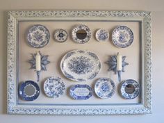 blue and white plates are arranged on the wall