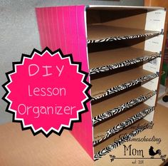 the diy lesson organizer is made from cardboard and has pink dividers on it