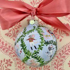 a christmas ornament with a red bow on it