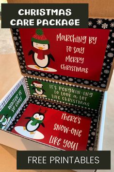 two boxes with christmas cards in them sitting on top of a table