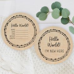 two wooden coasters that say hello world and i'm new here