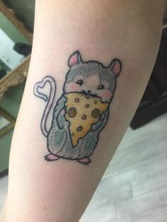 a small rat eating a piece of cheese tattoo on the right leg, it looks like he's eating pizza