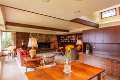 a living room filled with furniture and a fire place in the middle of a room