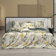 a bed with yellow flowers on it in a room next to a lamp and plant