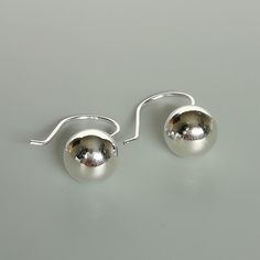 A PAIR of sterling silver ball danglers. These earrings are made of 925 hypoallergenic sterling silver. Size: 10 mm Drop length: 21 mm Weight: 2.5 gm All my pieces are sent in a gift box. I can include a personal message from you if needed. You are welcome to contact me at... bhavnakwintra1956@gmail.com More hoops: https://www.etsy.com/your/shops/TheSilverGame/tools/listings/section:26305414 More earrings: https://www.etsy.com/your/shops/TheSilverGame/tools/listings/section:26308789 Ear climbers Silver Dainty Earrings Simple Design, Dainty Silver Earrings With Simple Design, Simple Sterling Silver Earrings As Gift, Sterling Silver Simple Design Earrings For Gift, Classic Sterling Silver Earrings With Simple Design, Elegant Sterling Silver Earrings With Simple Design, Dainty Sterling Silver Earrings With Simple Design, Silver Round Dainty Earrings, Silver Dainty Round Earrings