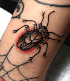 a spider tattoo on the leg of a person's arm with an eyeball in it