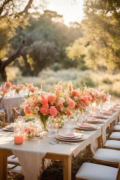 an outdoor dinner table set up with candles and flowers